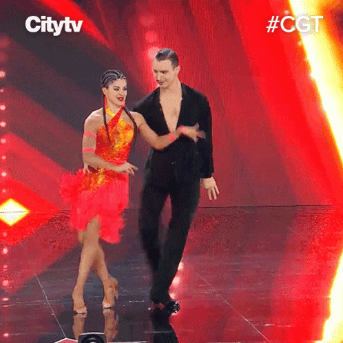 A Man And A Woman Are Dancing On A Stage With Citytv Written On The Bottom GIF