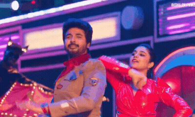 A Man And A Woman Are Dancing On Stage . GIF