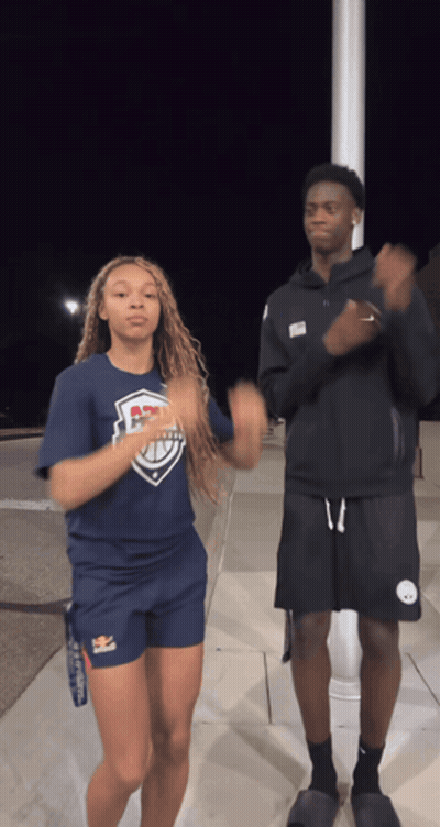 A Man And A Woman Are Dancing Together And The Woman Is Wearing A Shirt That Says ' Ucsd ' On It GIF