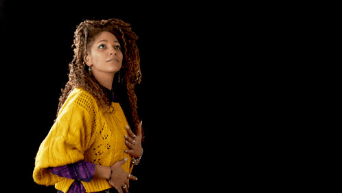 A Man And A Woman Are Dancing Together And The Woman Is Wearing A Yellow Sweater GIF