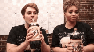 A Man And A Woman Are Drinking A Bottle Of Diet Root Beer GIF