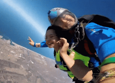 A Man And A Woman Are Flying Through The Air And The Woman Is Wearing A Shirt That Says ' I Love You ' GIF