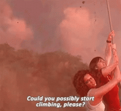 A Man And A Woman Are Hanging From A Rope . GIF