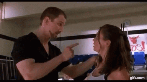 A Man And A Woman Are Having A Fight In A Gym . GIF