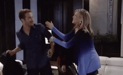A Man And A Woman Are Having A Fight In A Living Room . GIF