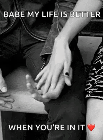 A Man And A Woman Are Holding Hands In A Black And White Photo With A Quote . GIF