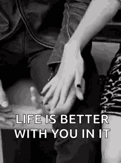 A Man And A Woman Are Holding Hands In A Black And White Photo With The Words `` Life Is Better With You In It '' . GIF