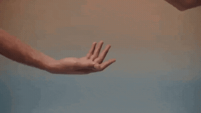 A Man And A Woman Are Holding Hands In A Close Up Of Their Hands . GIF