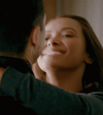 A Man And A Woman Are Hugging And Kissing GIF