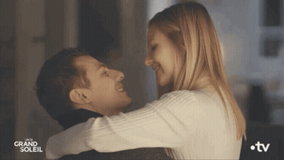 A Man And A Woman Are Hugging And Looking At Each Other With The Words Grand Soleil On The Bottom GIF