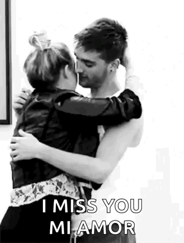 A Man And A Woman Are Hugging Each Other And Kissing . GIF