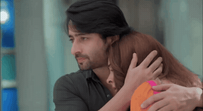 A Man And A Woman Are Hugging Each Other And The Man Is Holding The Woman 'S Head . GIF