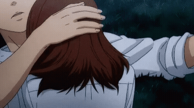 A Man And A Woman Are Hugging Each Other And The Woman Is Touching The Man 'S Hair . GIF