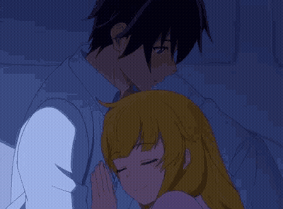 A Man And A Woman Are Hugging Each Other In A Dark Room . GIF