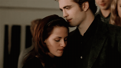 A Man And A Woman Are Hugging Each Other GIF