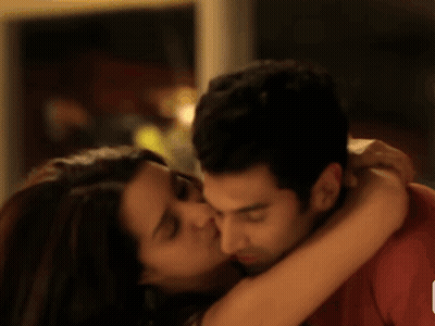 A Man And A Woman Are Hugging Each Other GIF