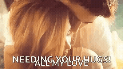 A Man And A Woman Are Hugging Each Other With The Words `` Needing Your Hugs ! '' GIF