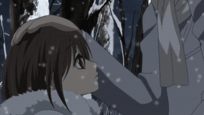 A Man And A Woman Are Hugging In The Snow GIF