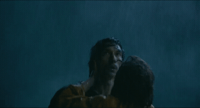 A Man And A Woman Are Hugging In The Water And The Woman Is Holding The Man 'S Neck . GIF