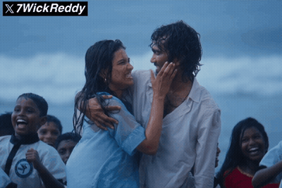 A Man And A Woman Are Hugging On A Beach With X7wick Reddy Written Above Them GIF