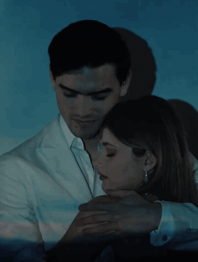 A Man And A Woman Are Hugging With The Words Culpa Nuestra Written Below Them GIF