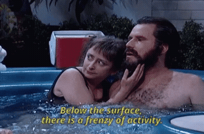 A Man And A Woman Are In A Hot Tub And The Woman Says Below The Surface There Is A Frenzy Of Activity GIF