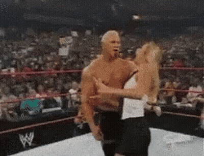 A Man And A Woman Are In A Wrestling Ring . GIF
