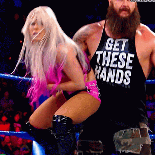 A Man And A Woman Are In A Wrestling Ring And The Man Is Wearing A Tank Top That Says Get These Hands GIF