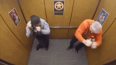 A Man And A Woman Are In An Elevator With A Sign That Says El Paso County Sheriff 'S Office GIF