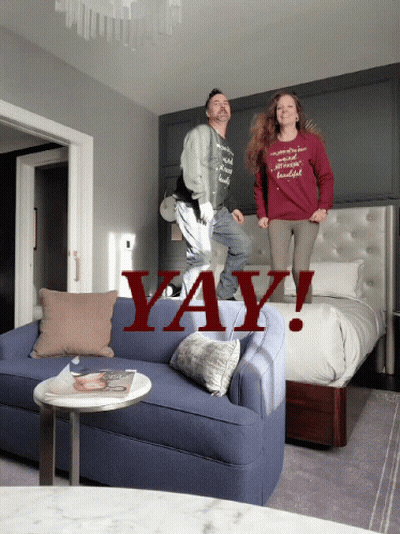 A Man And A Woman Are Jumping On A Couch With The Word Yay Written In Red GIF