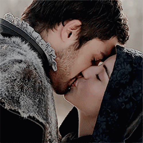 A Man And A Woman Are Kissing And The Woman Is Wearing A Black Veil GIF