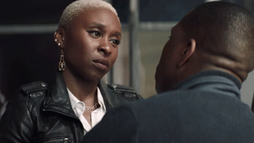A Man And A Woman Are Kissing And The Woman Is Wearing Earrings GIF