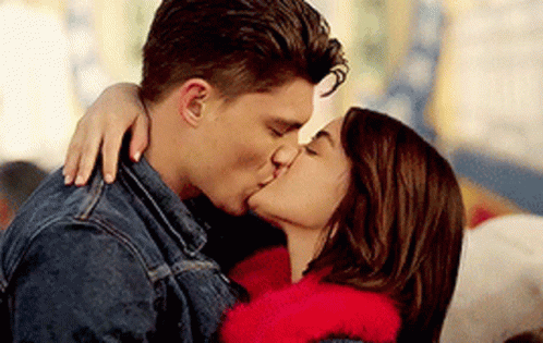 A Man And A Woman Are Kissing Each Other . GIF