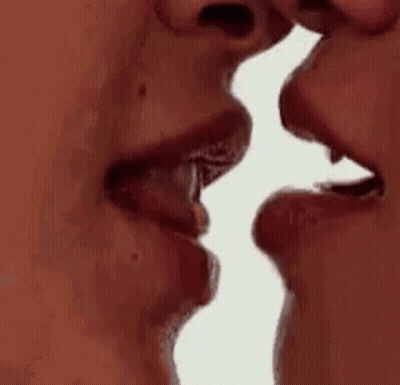 A Man And A Woman Are Kissing Each Other . GIF