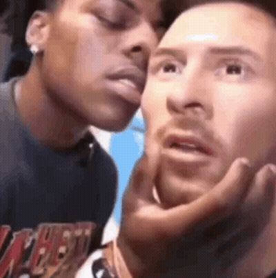 A Man And A Woman Are Kissing Each Other On The Cheeks . GIF