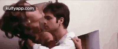A Man And A Woman Are Kissing Each Other On The Neck . GIF