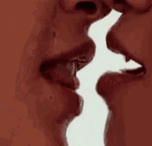A Man And A Woman Are Kissing Each Other With Their Mouths Open . GIF