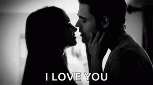 A Man And A Woman Are Kissing In A Black And White Photo With The Words `` I Love You '' . GIF