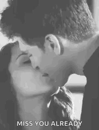 A Man And A Woman Are Kissing In A Black And White Photo With The Words `` Miss You Already '' . GIF