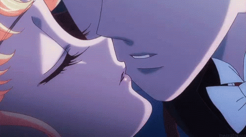 A Man And A Woman Are Kissing In A Close Up Of Their Faces GIF