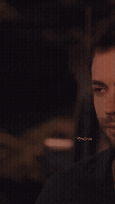 A Man And A Woman Are Kissing In A Dark Room With The Words Moreelle Lia On The Bottom GIF