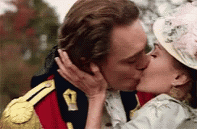 A Man And A Woman Are Kissing In A Military Uniform And Hat . GIF