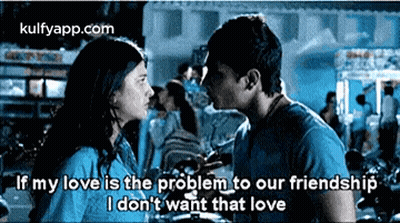 A Man And A Woman Are Kissing In Front Of A Crowd And The Man Is Saying That His Love Is The Problem To Our Friendship . GIF