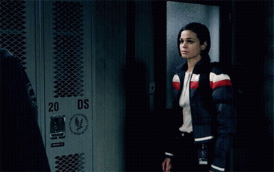 A Man And A Woman Are Kissing In Front Of Lockers With The Number 34 On Them GIF
