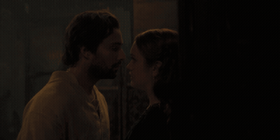 A Man And A Woman Are Kissing In The Dark GIF