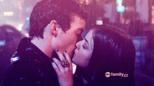 A Man And A Woman Are Kissing In The Rain With Abc Family Hd Written On The Bottom GIF