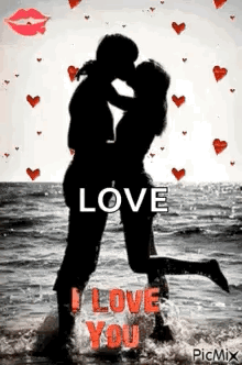 A Man And A Woman Are Kissing On The Beach With Hearts Flying Around Them . GIF