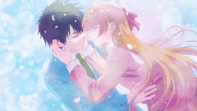 A Man And A Woman Are Kissing With Petals Flying Around Them GIF
