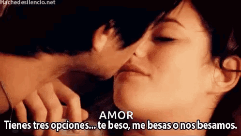 A Man And A Woman Are Kissing With The Words Amor Written On The Bottom . GIF