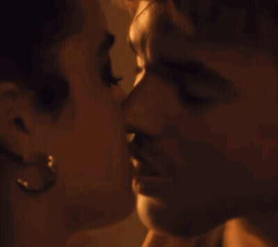 A Man And A Woman Are Kissing With Their Eyes Closed GIF